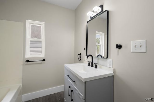 321 Pleasant Ave, Oneida-Inside, NY 13421 - full bathroom featuring vanity, wood finished floors, and a tub to relax in