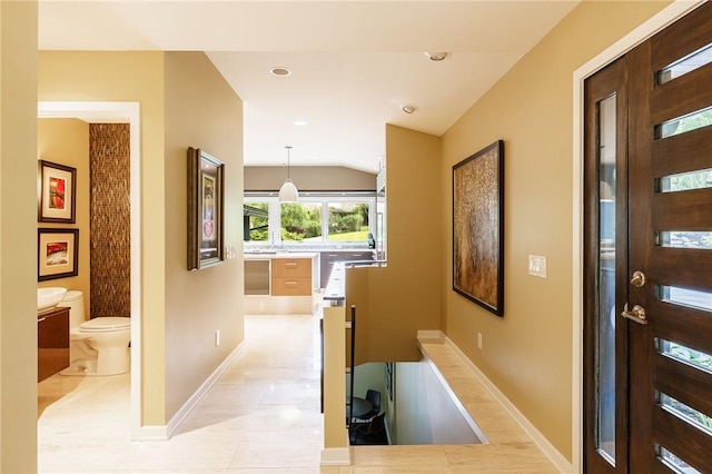 5 Elmwood Hill Ln, Brighton, NY 14610 - hallway featuring light tile patterned flooring and vaulted ceiling
