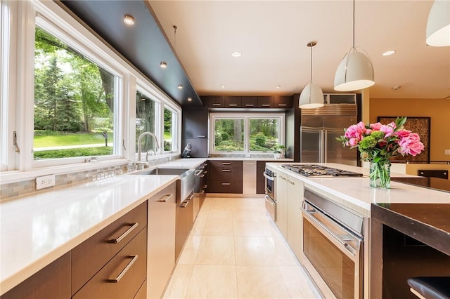 5 Elmwood Hill Ln, Brighton, NY 14610 - kitchen featuring modern cabinets, light countertops, light tile patterned flooring, appliances with stainless steel finishes, and decorative backsplash