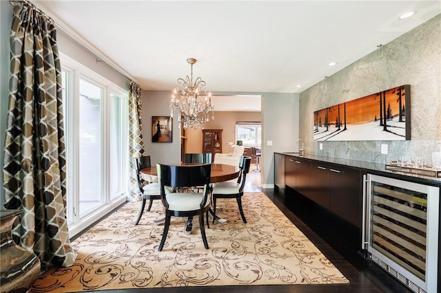 5 Elmwood Hill Ln, Brighton, NY 14610 - dining area with wine cooler, a bar, a chandelier, dark wood-style floors, and recessed lighting
