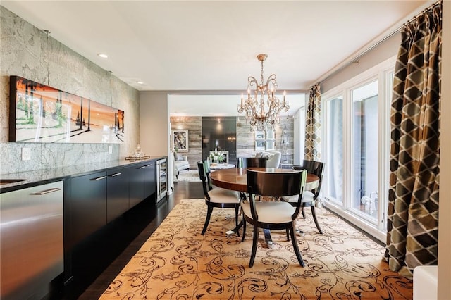5 Elmwood Hill Ln, Brighton, NY 14610 - dining area featuring beverage cooler, a chandelier, and wood finished floors