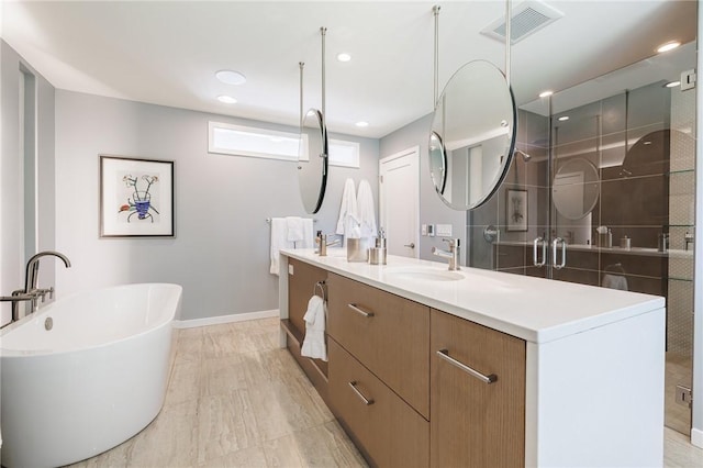5 Elmwood Hill Ln, Brighton, NY 14610 - full bathroom featuring double vanity, a freestanding tub, and a stall shower