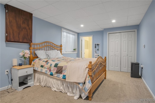 2391 Hess Rd, Newfane, NY 14008 - carpeted bedroom featuring a closet, a paneled ceiling, recessed lighting, and connected bathroom