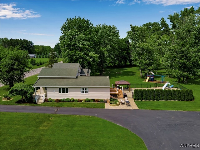 2391 Hess Rd, Newfane, NY 14008 - view of front facade with a playground, a front lawn, and view of scattered trees
