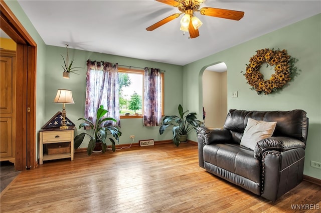 2391 Hess Rd, Newfane, NY 14008 - living room featuring arched walkways, wood finished floors, and ceiling fan