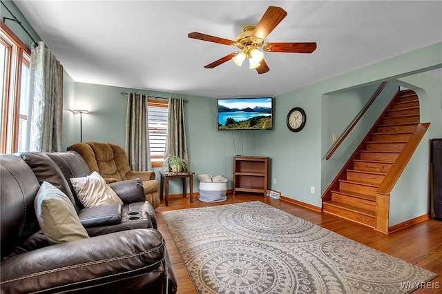 2391 Hess Rd, Newfane, NY 14008 - living area featuring a ceiling fan, stairway, and wood finished floors
