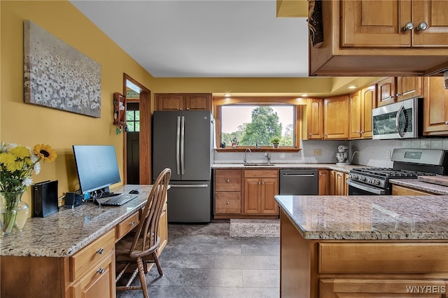 2391 Hess Rd, Newfane, NY 14008 - kitchen with stainless steel appliances, light stone countertops, an office area, brown cabinets, and light stone finish flooring