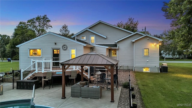 2391 Hess Rd, Newfane, NY 14008 - back of house at dusk featuring an outdoor living space, a lawn, a patio, and a gazebo
