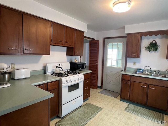 41 Evergreen St, Cortland, NY 13045 - kitchen featuring white gas stove, black microwave, light flooring, and light countertops