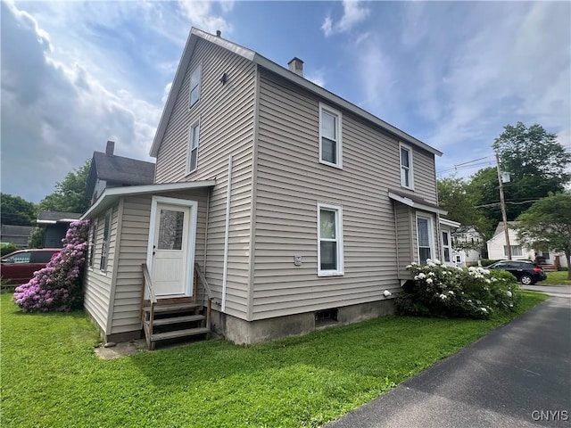 41 Evergreen St, Cortland, NY 13045 - view of home's exterior featuring entry steps, a yard, and a chimney