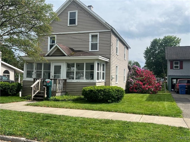 41 Evergreen St, Cortland, NY 13045 - american foursquare style home featuring a sunroom and a front yard