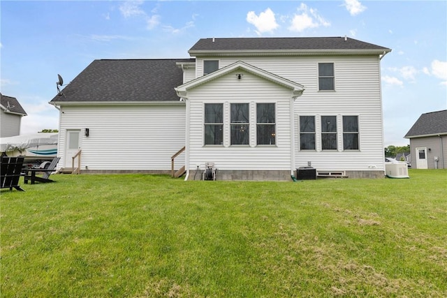 591 Whistlers Cove Ln, Greece, NY 14612 - back of house with a lawn and a shingled roof
