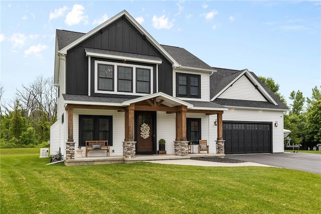 591 Whistlers Cove Ln, Greece, NY 14612 - craftsman-style house featuring a porch, board and batten siding, asphalt driveway, a front lawn, and an attached garage