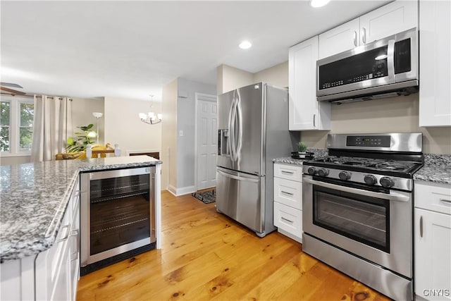8185 Mantova Dr, Clay, NY 13041 - kitchen with stainless steel appliances, wine cooler, white cabinetry, and recessed lighting
