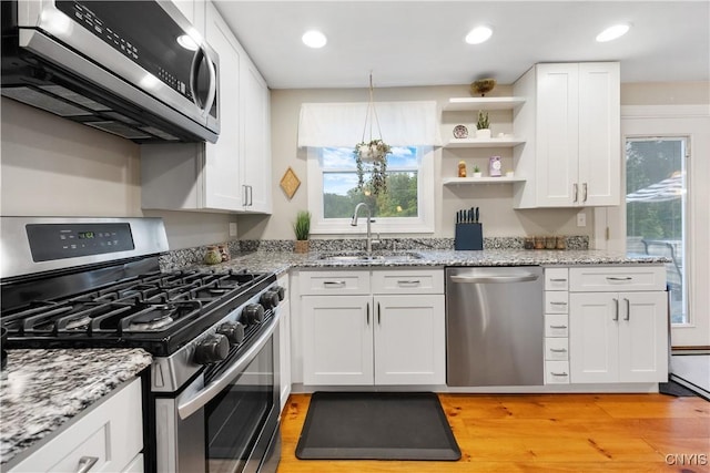 8185 Mantova Dr, Clay, NY 13041 - kitchen featuring stainless steel appliances, plenty of natural light, white cabinets, and recessed lighting