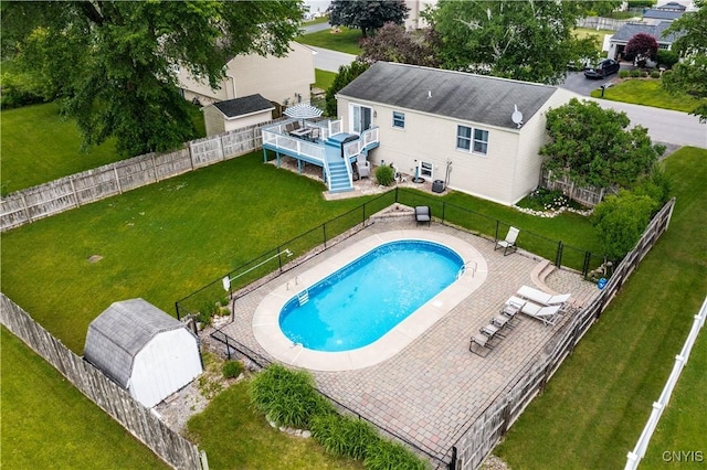 8185 Mantova Dr, Clay, NY 13041 - view of swimming pool with a fenced backyard, a deck, and an outbuilding