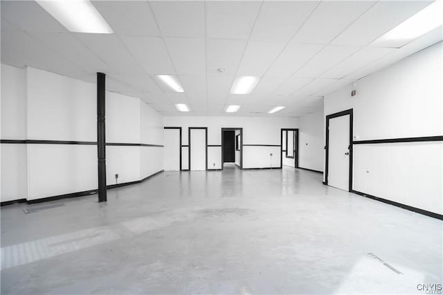 151 Oak St, Syracuse, NY 13203 - unfurnished room with concrete floors and a paneled ceiling