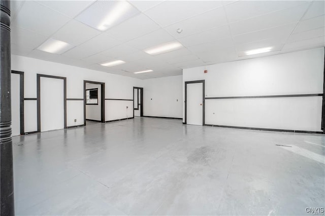 151 Oak St, Syracuse, NY 13203 - unfurnished room with a paneled ceiling and concrete flooring