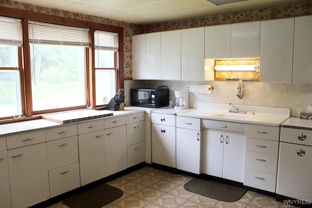 5046 Whig St, Little Valley, NY 14779 - kitchen featuring black microwave, light countertops, light flooring, and white cabinets