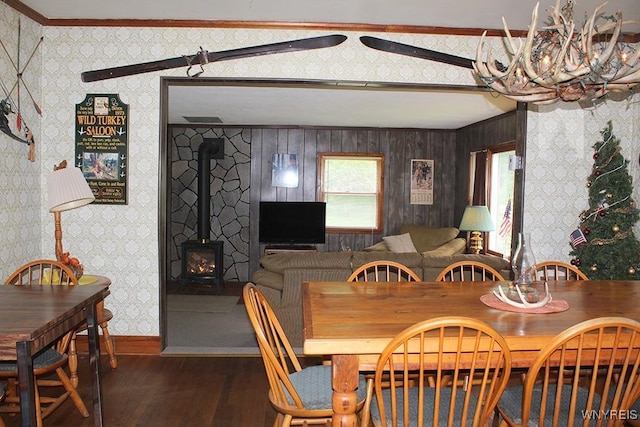 5046 Whig St, Little Valley, NY 14779 - dining room with a chandelier, crown molding, wood finished floors, wallpapered walls, and a wood stove