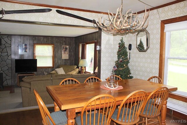 5046 Whig St, Little Valley, NY 14779 - dining space with a chandelier, wood finished floors, wallpapered walls, crown molding, and wooden walls