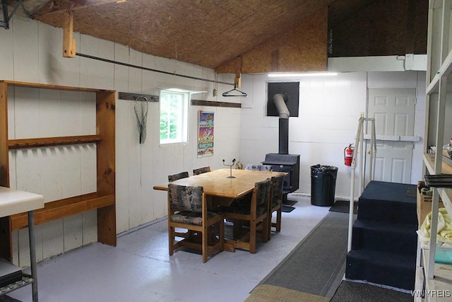 5046 Whig St, Little Valley, NY 14779 - dining area featuring a wood stove, concrete flooring, and lofted ceiling