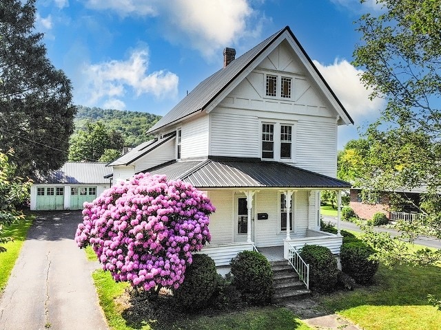 306 Broad St, Port Allegany Boro, PA 16743 - view of front of home with covered porch, a metal roof, asphalt driveway, and a chimney