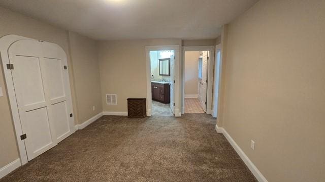 306 Broad St, Port Allegany Boro, PA 16743 - unfurnished bedroom featuring dark carpet and ensuite bathroom