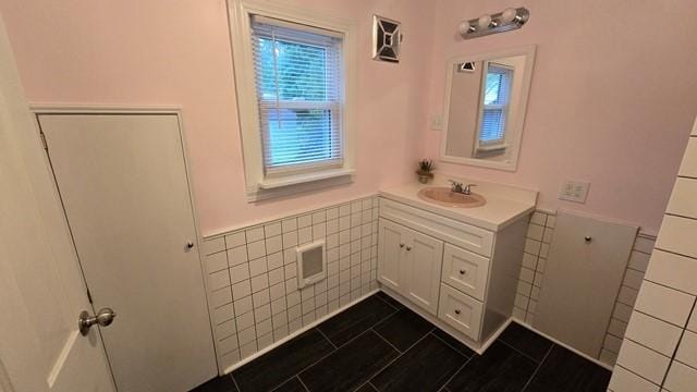 306 Broad St, Port Allegany Boro, PA 16743 - bathroom featuring tile walls, vanity, and wainscoting