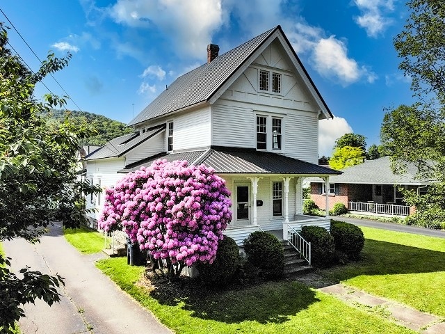 306 Broad St, Port Allegany Boro, PA 16743 - view of front of house featuring covered porch, a metal roof, and a front lawn