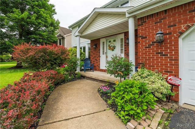 64 Bywater Dr, Amherst, NY 14068 - property entrance featuring brick siding, covered porch, and an attached garage