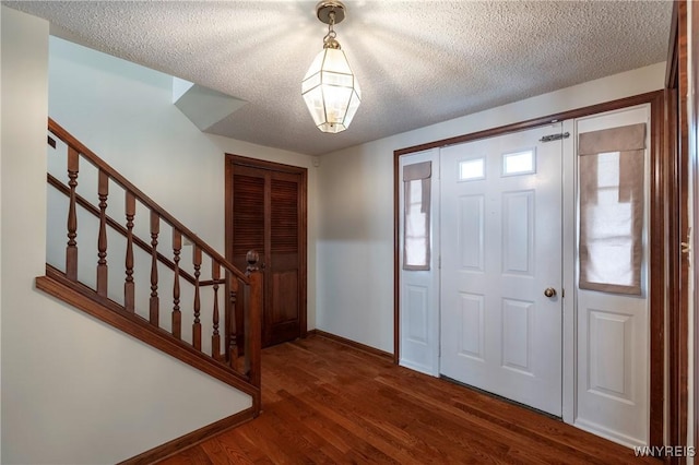 64 Bywater Dr, Amherst, NY 14068 - foyer featuring stairs, a textured ceiling, and dark wood finished floors