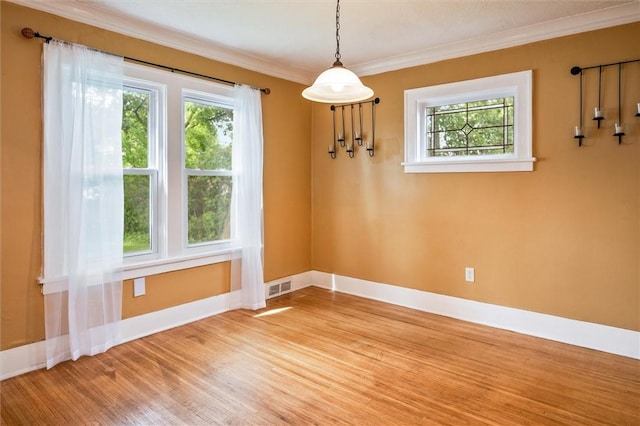 199 Brett Rd, Irondequoit, NY 14609 - unfurnished dining area featuring plenty of natural light, ornamental molding, and wood finished floors