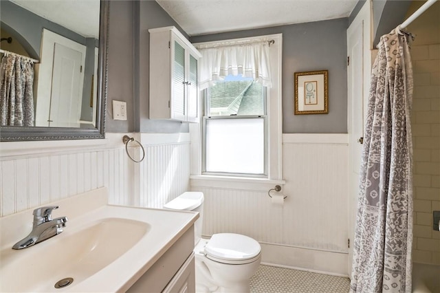 199 Brett Rd, Irondequoit, NY 14609 - bathroom with wainscoting, vanity, and healthy amount of natural light
