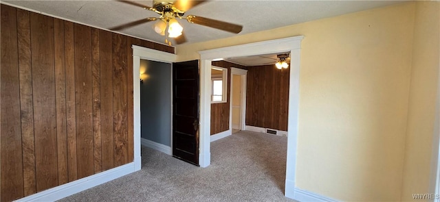 129 Albert Ave, Buffalo, NY 14207 - empty room featuring ceiling fan, wood walls, and carpet flooring