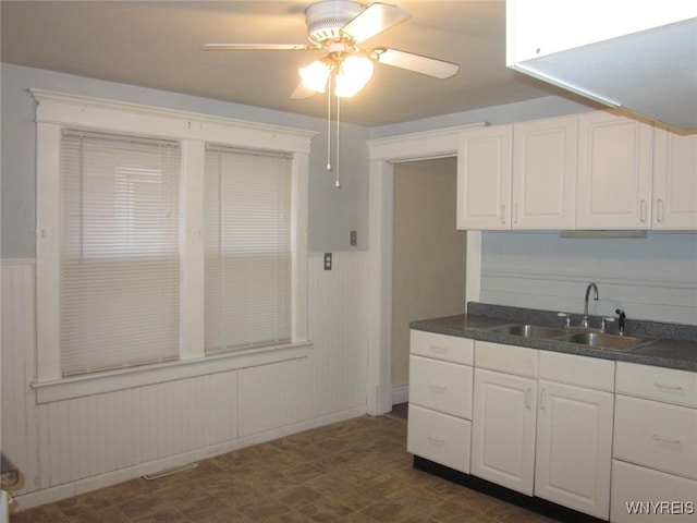 129 Albert Ave, Buffalo, NY 14207 - kitchen featuring ceiling fan, dark countertops, white cabinetry, and dark floors