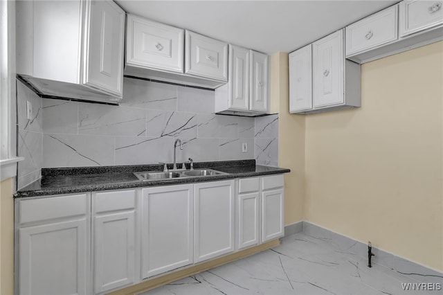 275 Olympic Ave, Buffalo, NY 14215 - kitchen with dark countertops, white cabinets, light marble finish flooring, and tasteful backsplash