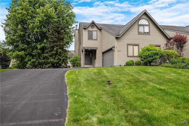 4797 Huntwood, Manlius, NY 13104 - traditional home with a front yard, a garage, and asphalt driveway