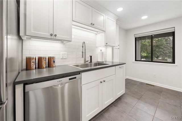 4797 Huntwood, Manlius, NY 13104 - kitchen with stainless steel appliances, dark countertops, decorative backsplash, white cabinetry, and tile patterned floors