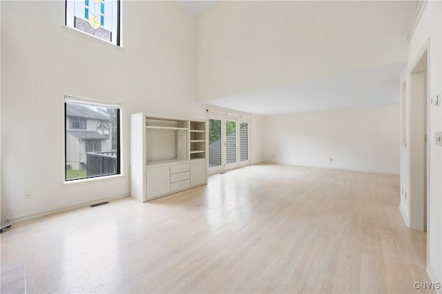 4797 Huntwood, Manlius, NY 13104 - unfurnished living room featuring light wood-type flooring and a high ceiling