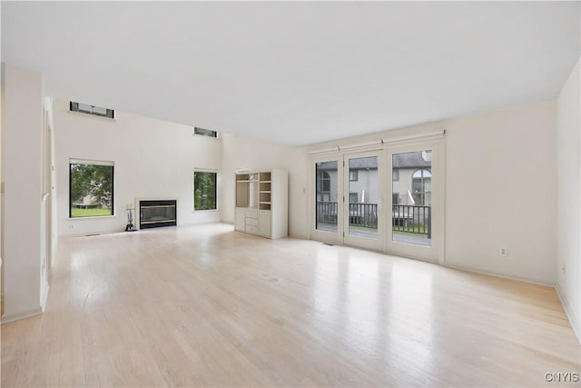 4797 Huntwood, Manlius, NY 13104 - unfurnished living room with a glass covered fireplace and wood finished floors