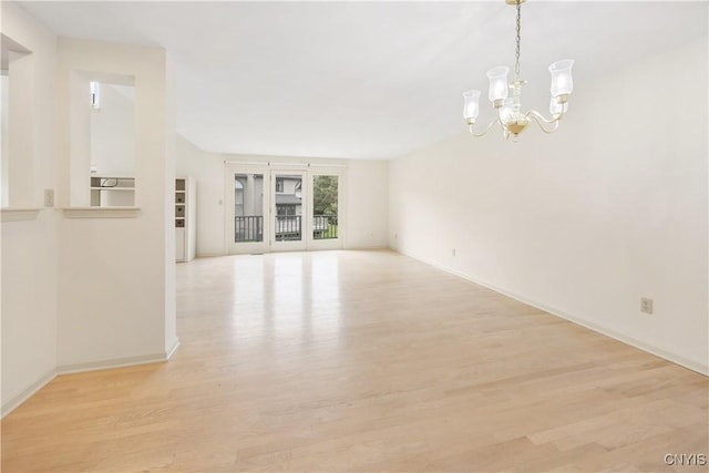 4797 Huntwood, Manlius, NY 13104 - empty room with a chandelier and light wood-style floors