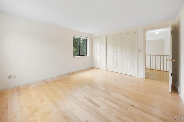 4797 Huntwood, Manlius, NY 13104 - unfurnished bedroom featuring two closets and light wood-style floors