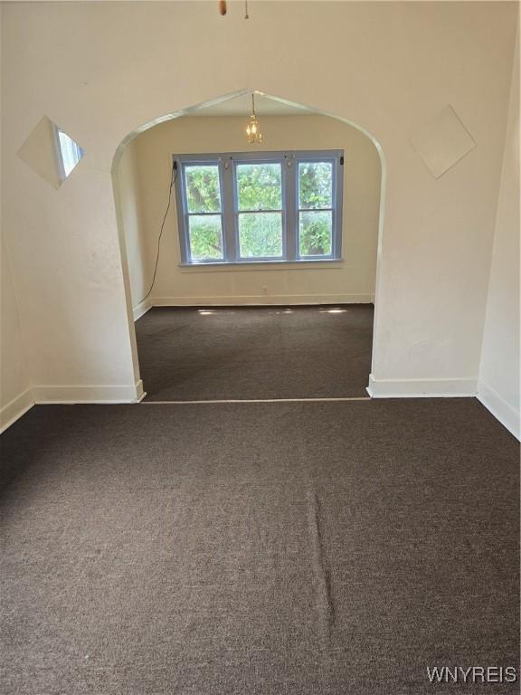 1310 E Lovejoy St, Buffalo, NY 14206 - spare room with dark colored carpet and arched walkways