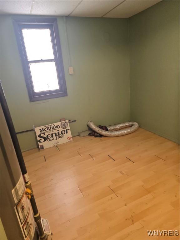 1310 E Lovejoy St, Buffalo, NY 14206 - spare room featuring wood finished floors and a drop ceiling