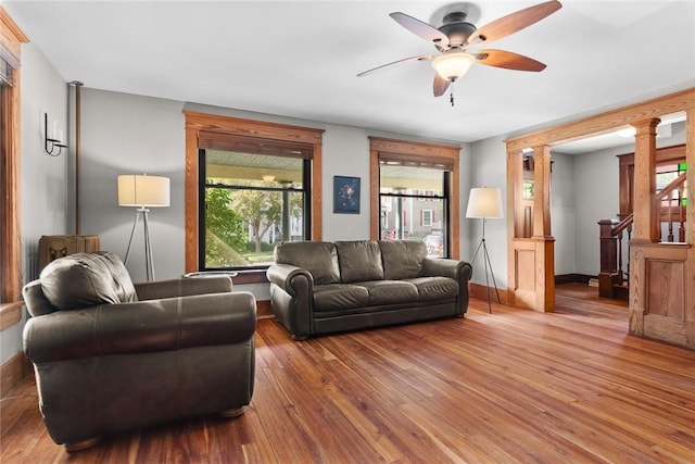 9 Orchard St, Delhi, NY 13753 - living room with hardwood / wood-style floors, ceiling fan, ornate columns, and stairway