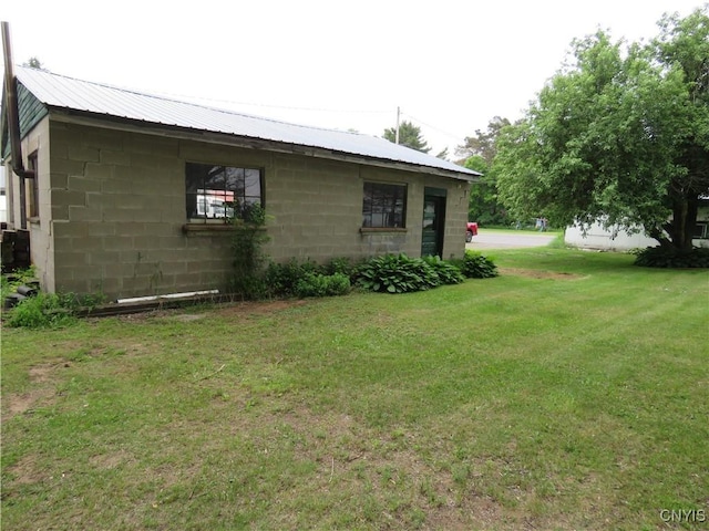 7285 State Route 812, Lowville, NY 13367 - view of property exterior with concrete block siding, a yard, and a metal roof