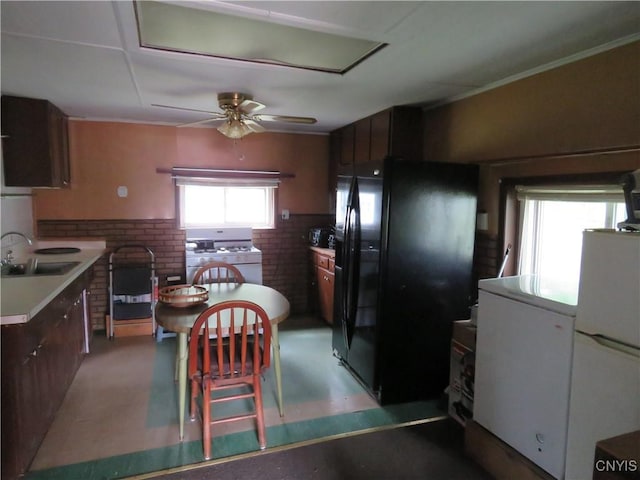 7285 State Route 812, Lowville, NY 13367 - kitchen featuring white appliances, ceiling fan, tile patterned floors, light countertops, and a wainscoted wall