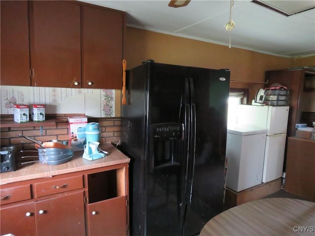 7285 State Route 812, Lowville, NY 13367 - kitchen featuring black fridge with ice dispenser, backsplash, freestanding refrigerator, tile countertops, and ornamental molding