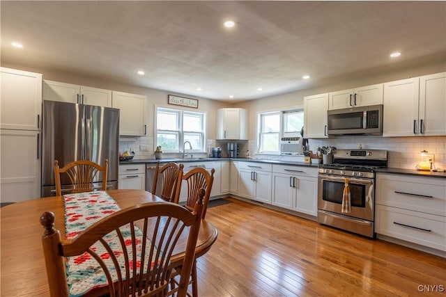 4045 E Milestrip Rd, Fenner, NY 13032 - kitchen featuring appliances with stainless steel finishes, dark countertops, backsplash, recessed lighting, and white cabinetry